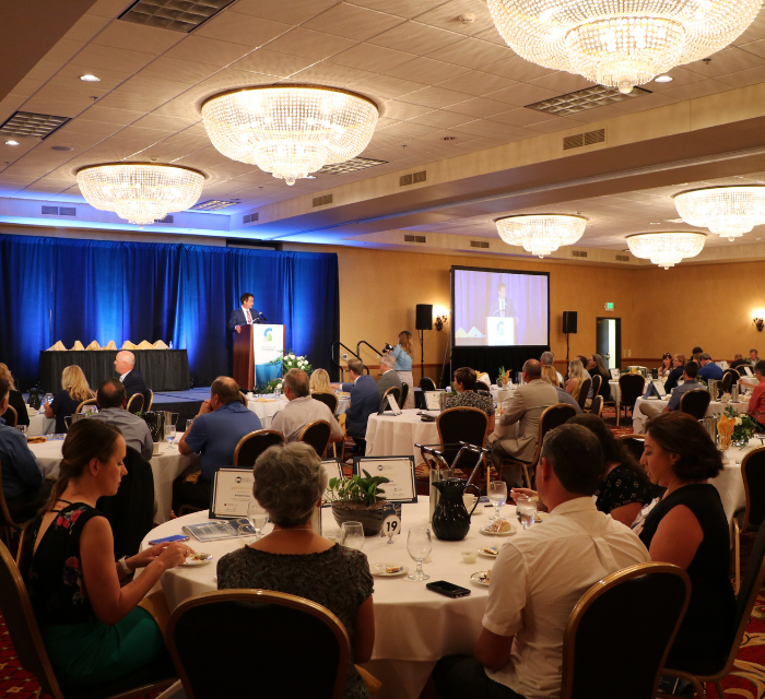 conference event with a speaker on stage addressing the audience