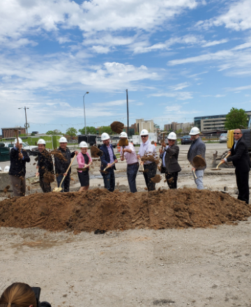 Greater Green Bay members in hard hat digging
